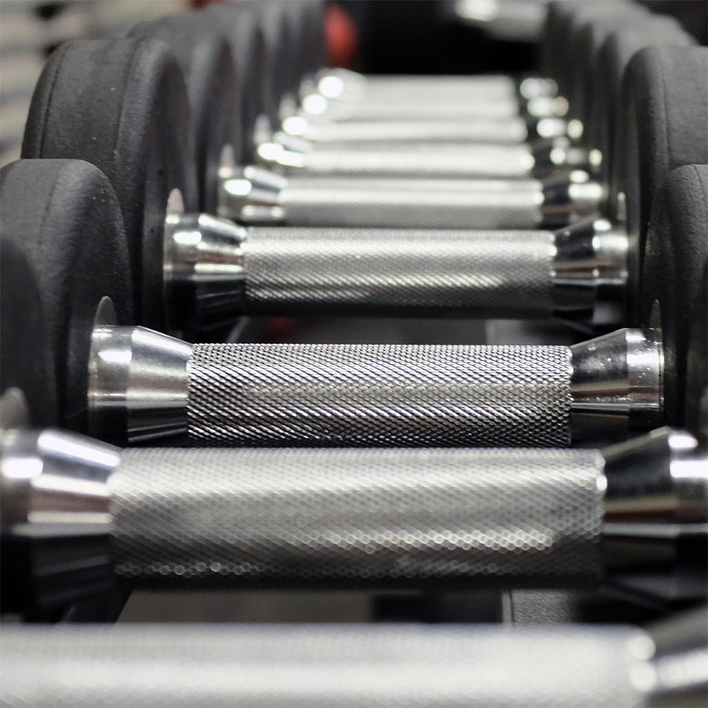 Body-Solid SDP round rubber dumbbell set on rack